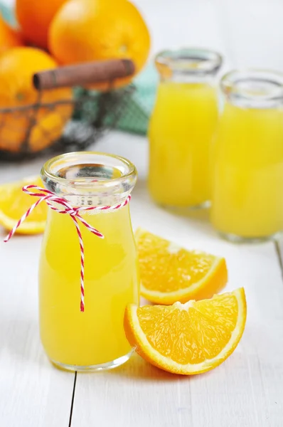Orange juice in glass jars — Stock Photo, Image