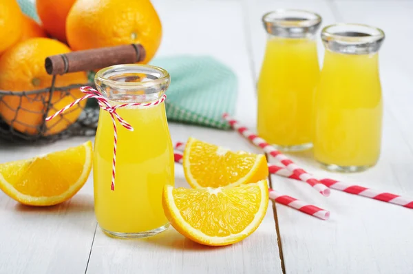 Orange juice in glass jars — Stock Photo, Image