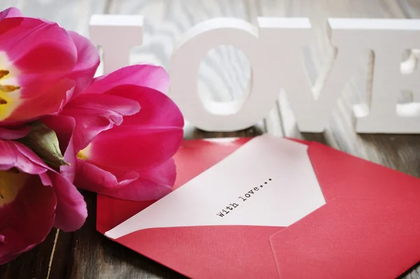 Tulips and red open envelope — Stock Photo, Image