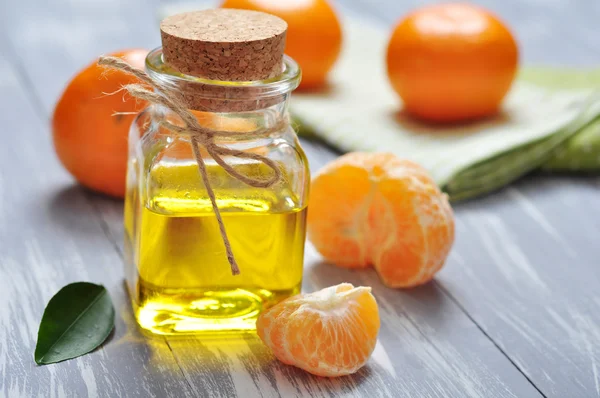 Tangerine oil in a glass bottle — Stock Photo, Image