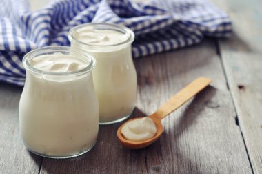 Greek yogurt in a glass jars clipart