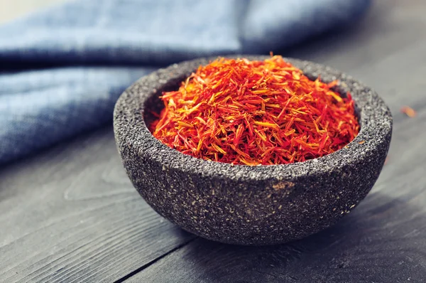 Saffron in stone bowl — Stock Photo, Image