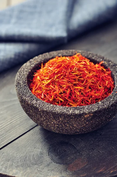 Saffron in stone bowl — Stock Photo, Image