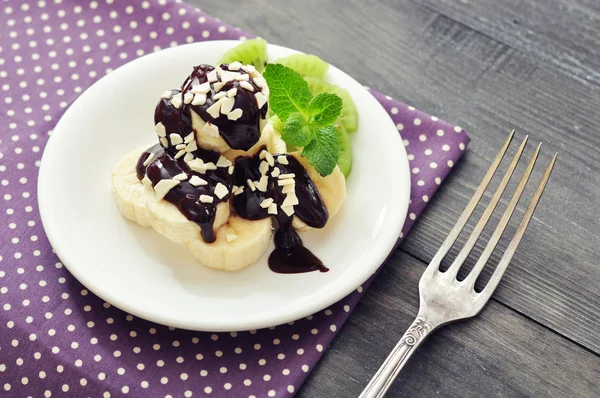 Banana with melted chocolate — Stock Photo, Image