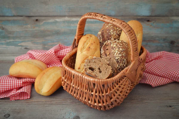 Bread and rolls in wicker basket — Stock Photo, Image