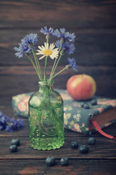 Cornflowers in vintage bottle — Stock Photo, Image