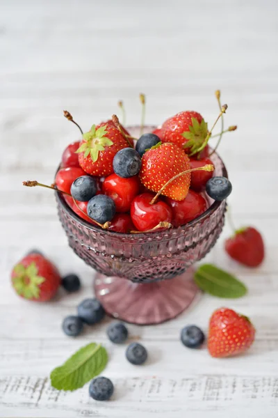 Berries in glass vase — Stock Photo, Image