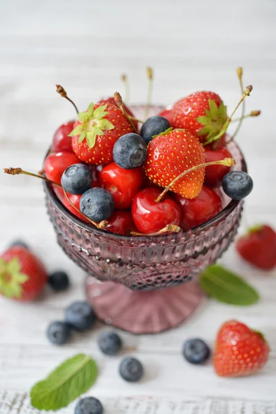 Berries in glass vase — Stock Photo, Image