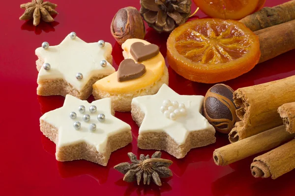 Dettaglio di deliziosi biscotti natalizi con spezie sul rosso — Foto Stock
