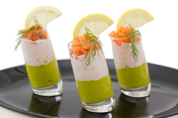 Salmon and avocado mousse on black plate — Stock Photo, Image