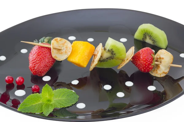 Mini blini (pancake) with cut fruits on skewers — Stock Photo, Image