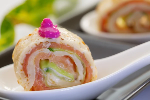 Smock salmon rolls with cucumber and crème fresh on white servi — 스톡 사진