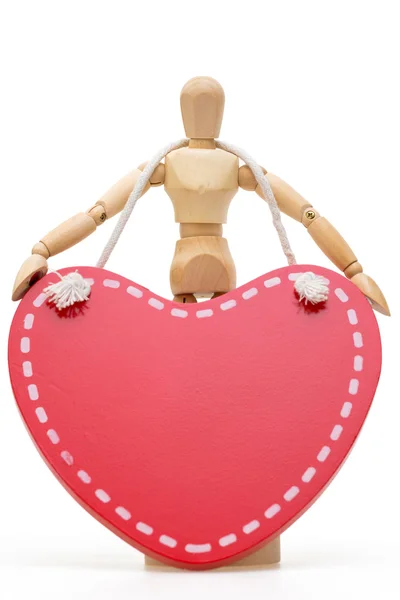 Wooden mannequin with large wooden red heart — Stock Photo, Image