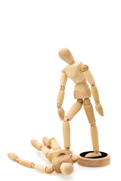 Concept of victor and beaten: one wooden mannequin doll standing over beating one Stock Image