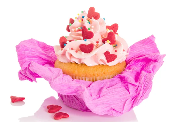 Vanilla cupcake with pink frosting and red hearts — Stock Photo, Image