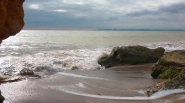 Karadeniz 'in kayalık kıyıları, Ukrayna' da fırtına sırasında sarı kumlu vahşi sahil.