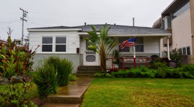 CALIFORNIA, USA - NOVEMBER 29, 2019: a typical small house of an American with a flag in the yard in Malibu on the ocean in California