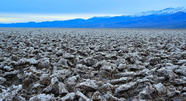 Death Valley National Park, Salt with clay, California. Smooth salt valley with cracked and swollen salt, dead salt landscape