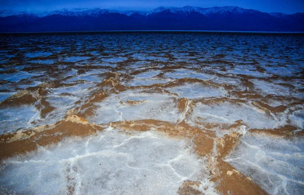 Death Valley National Park, Salt with clay, California. Smooth salt valley with cracked and swollen salt, dead salt landscape