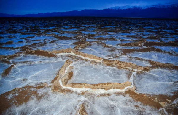 Death Valley National Park, Salt with clay, California. Smooth salt valley with cracked and swollen salt, dead salt landscape