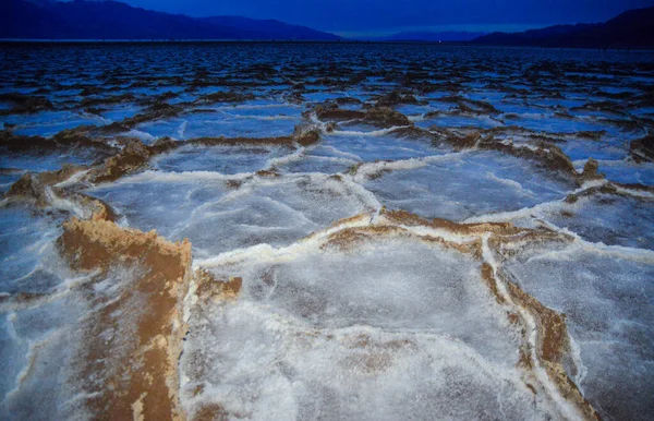 Death Valley National Park, Salt with clay, California. Smooth salt valley with cracked and swollen salt, dead salt landscape