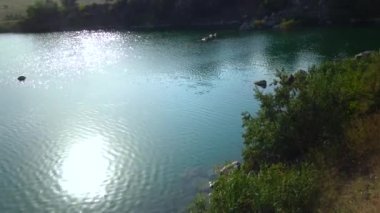 Glare on the water. Reflection of the sun in the lake water