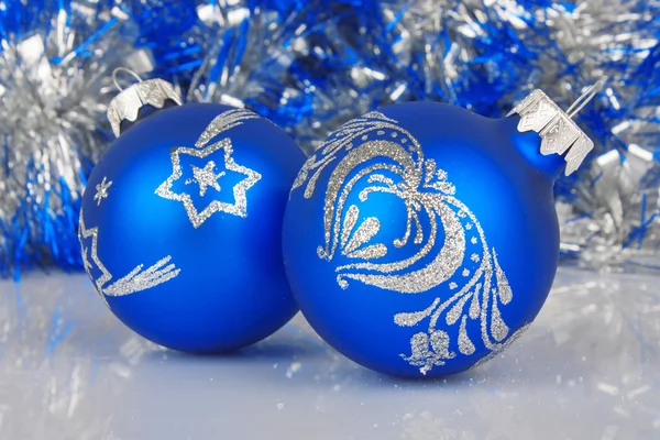 Christmas blue baubles against shiny background Royalty Free Stock Photos