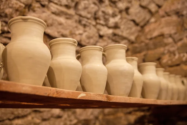 Pottery dishes on shelves — Stock Photo, Image