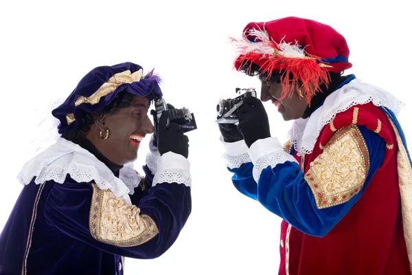 Zwarte Piet and his co-worker are taking photographs — Stock Photo, Image