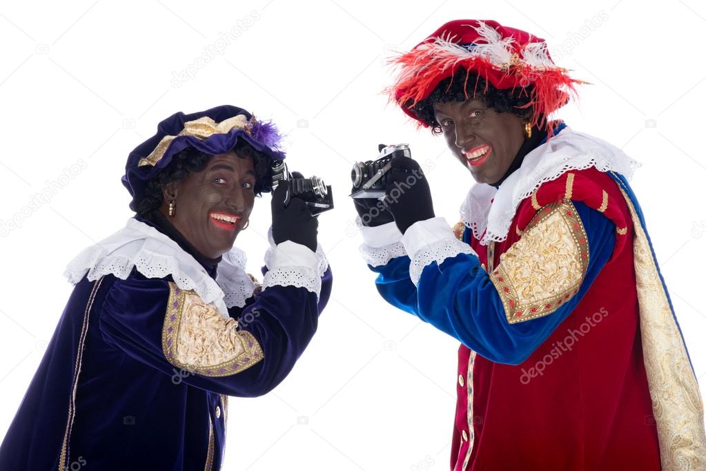 Zwarte Piet and his co-worker are taking photographs