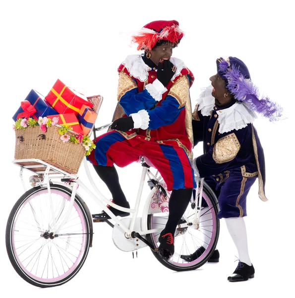 Zwarte piet på en cykel med presenter — Stockfoto