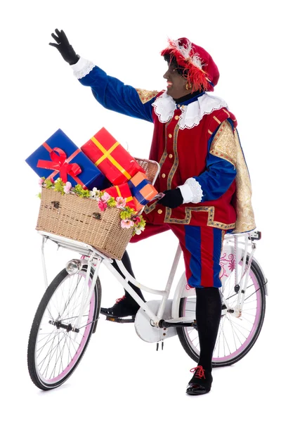 Zwarte piet auf einem Fahrrad mit Geschenken — Stockfoto
