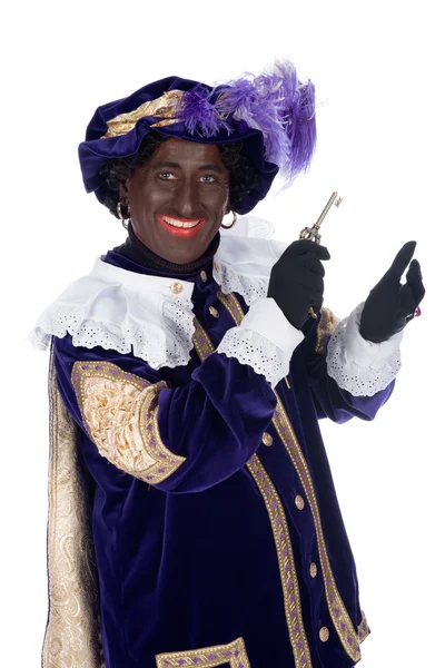 Zwarte piet en een sleutel van het huis van sinterklaas — Stockfoto