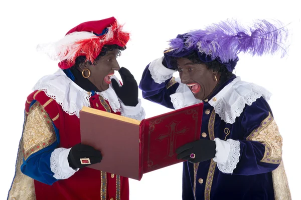 Zwarte piet und das Buch des Sinterklaas — Stockfoto