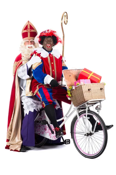 Sinterklaas en zwarte pete op een fiets — Stockfoto