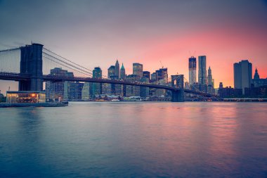 Brooklyn bridge and Manhattan at dusk clipart