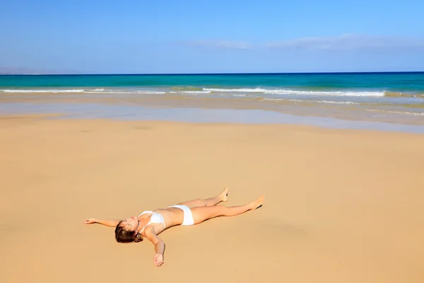 Jeune femme se détendre sur la plage de l'océan — Photo