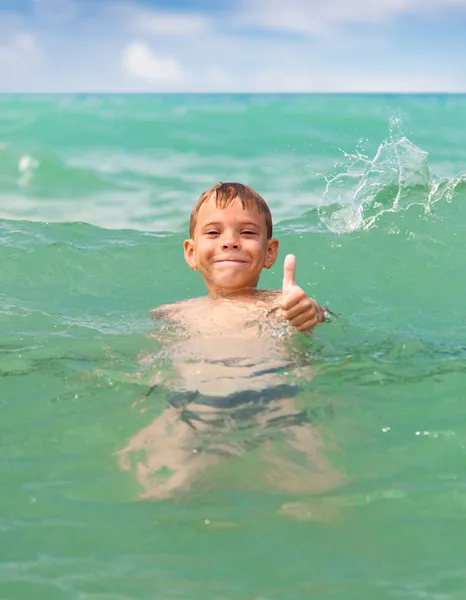 Cheerful boy swimming in the sea — Stock Photo, Image