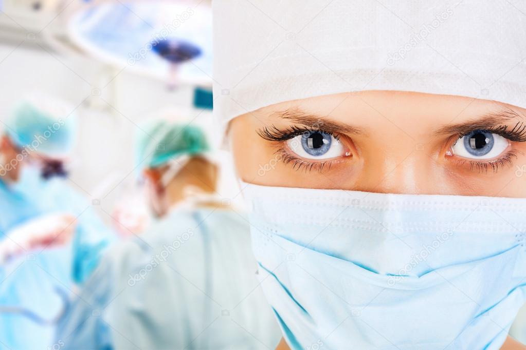 Close-up of a female surgeon with his team