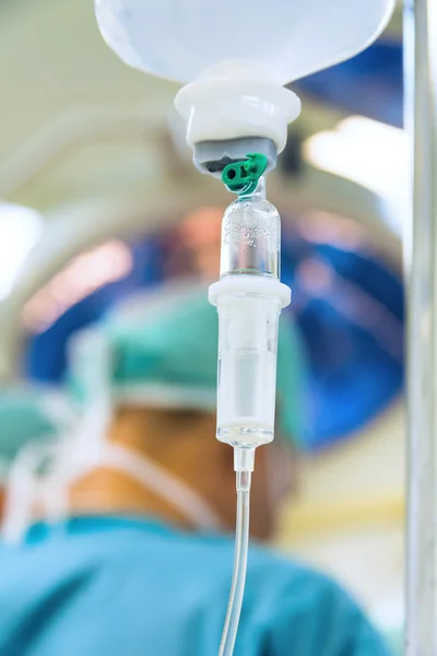 IV drip with surgeon on background — Stock Photo, Image