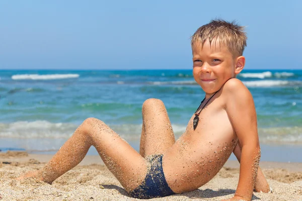 Little boy playing in sand on the beach Stock Photo