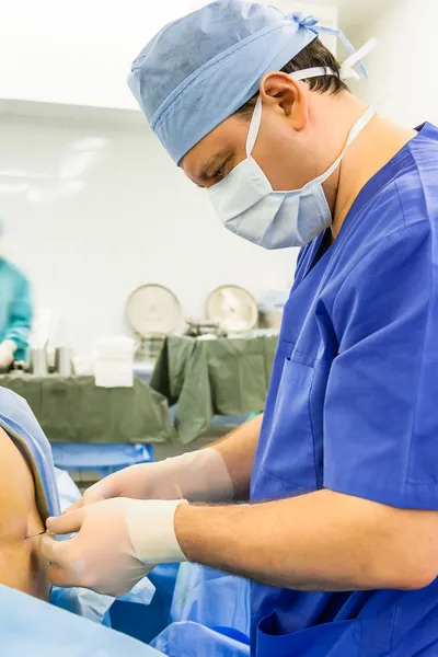 Doctor performing epidural anesthesia — Stock Photo, Image