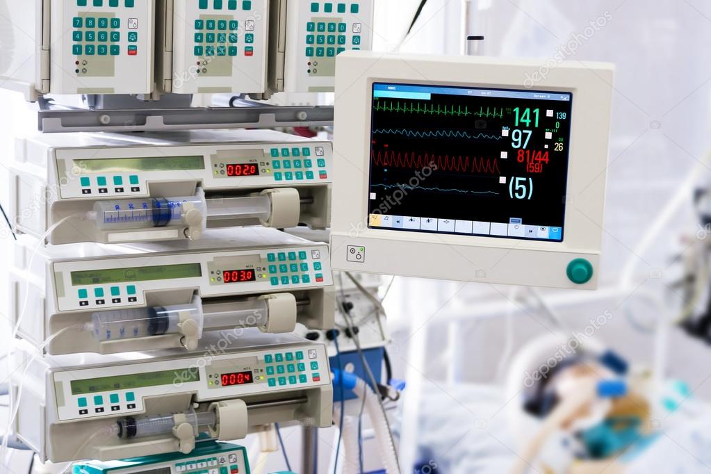 Patient with monitor and infusion pumps in an ICU