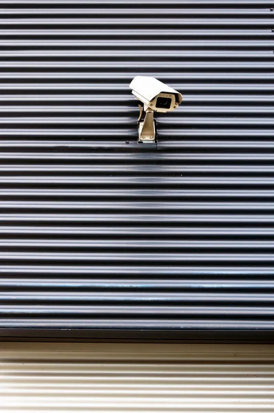 Security cctv camera on textured wall — Stock Photo, Image