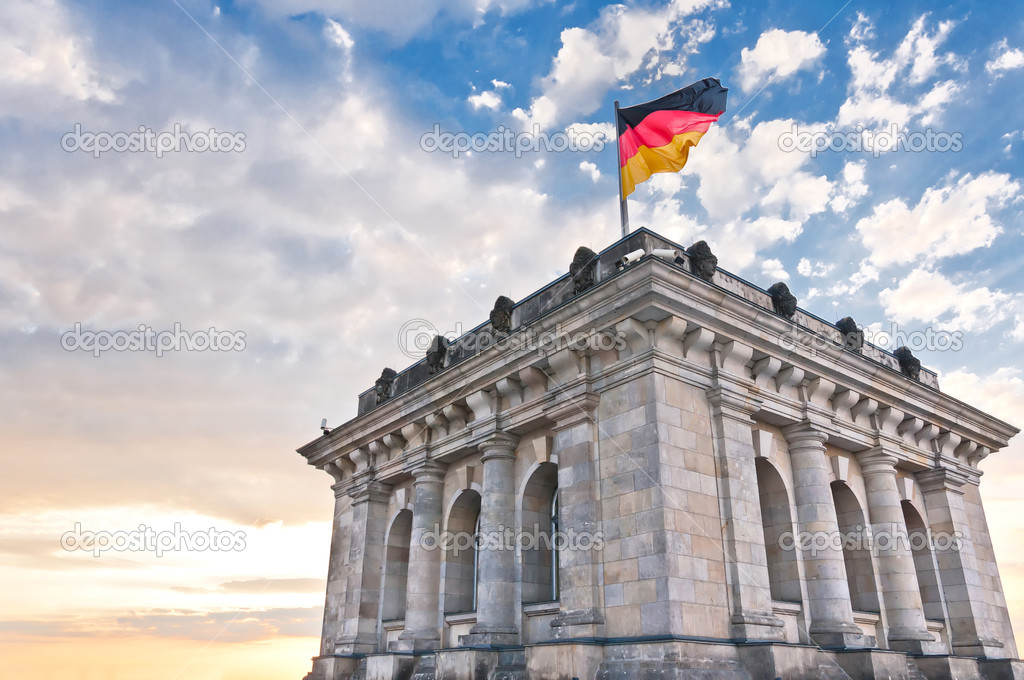 German Parliament with national flag in Berlin, Germany