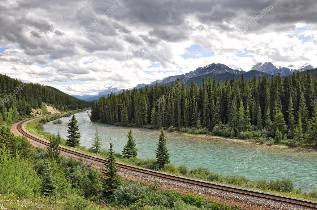 River, railway and Rocky Mountains in Banff National Park, Alberta