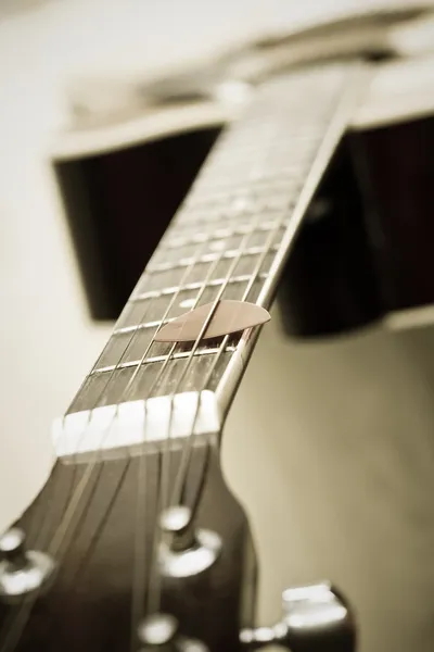 Guitar pick on the fingerboard Stock Photo