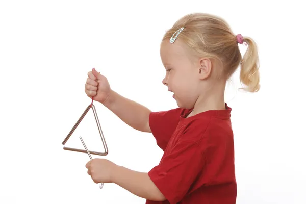 Dziewczynka gra trójkąt — Zdjęcie stockowe