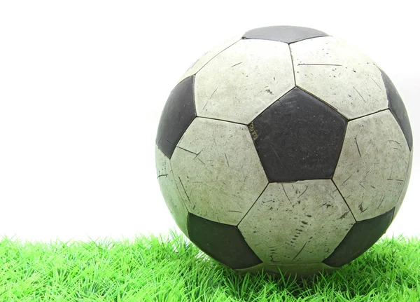 Grunge soccer football on green grass — Stock Photo, Image