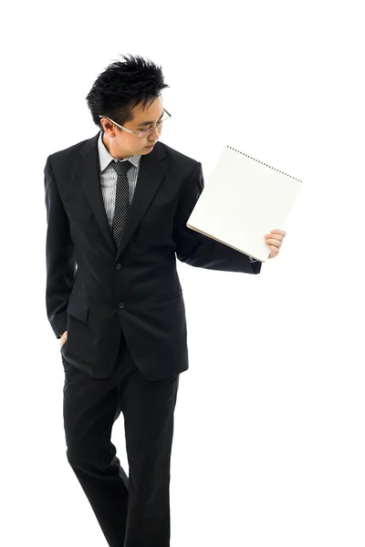 Empresário segurando livro em branco — Fotografia de Stock